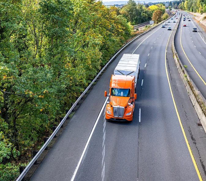 Orange freight truck on highway